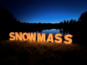 Marquee letters at lake stating "Snowmass" in Colorado